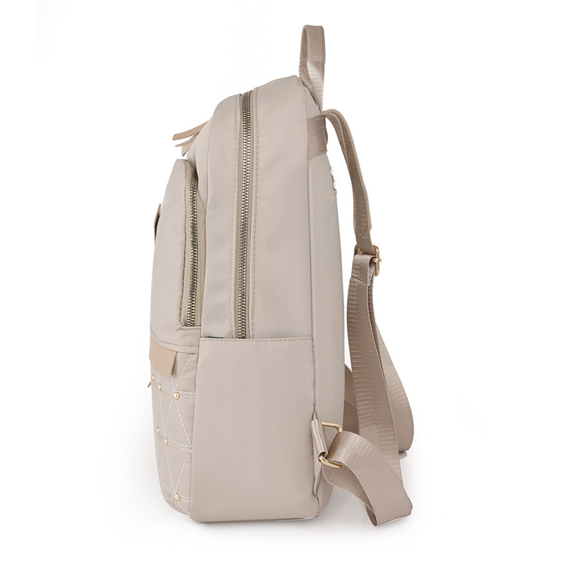 El fabricante emitió 2023 nuevas mochilas de nailon para mujer coreana, bordado de moda, remaches, mochila de viaje, mochila escolar para mujer