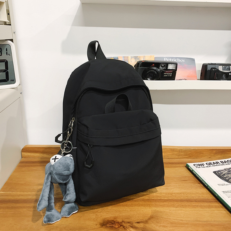 Las chicas japonesas de bolsos de lona son antiguas, impermeables, de color sólido, bolsos de nylon, Campus simple y versátil mochilas escolares para hombres de moda.