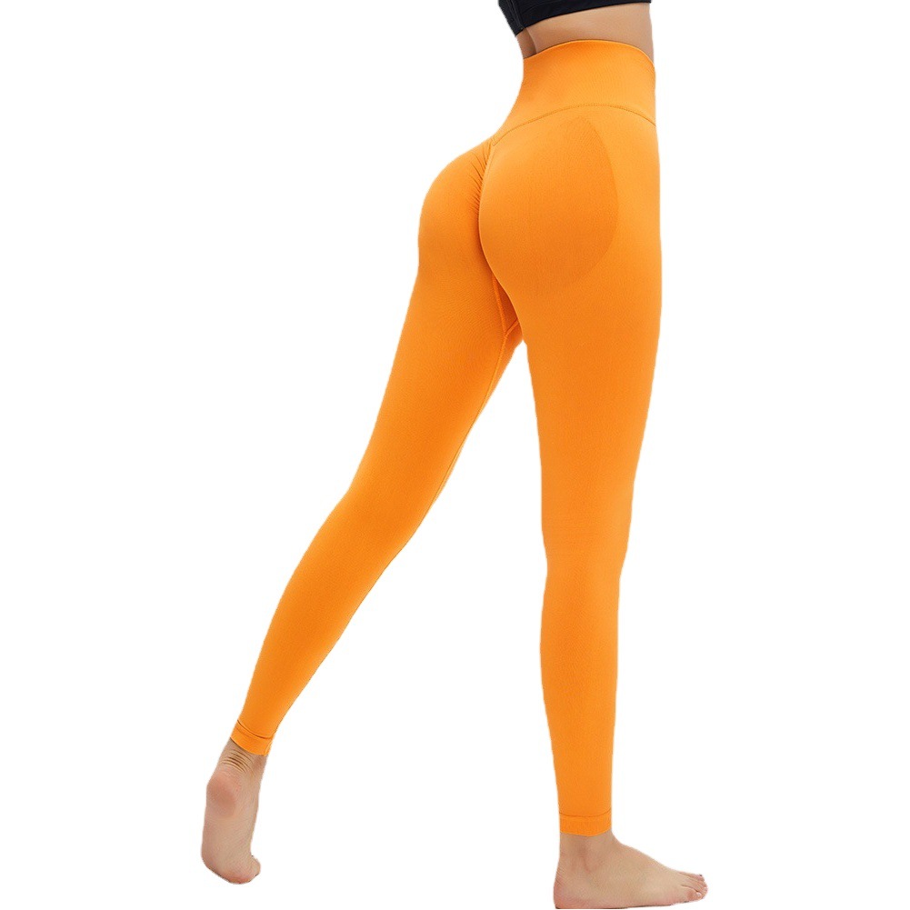 Nuevos pantalones de fitness de lycra transfronterizos de melocotón de cintura alta Mujer Desnuda cadera levantamiento apretado Pantalones deportivos pantalones de yoga sin costuras