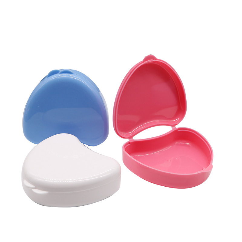 Caja de soporte de diente de plástico colorido caja de soporte de dentadura en forma de corazón caja de soporte de caja de diente pequeño lindo caja de almacenamiento de diente en forma de corazón al por mayor