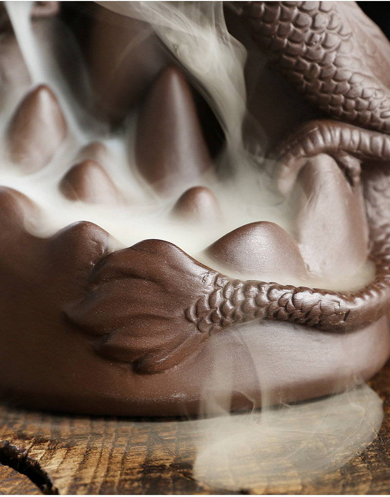 This handmade Purple Sand Dragon Backflow Incense Burner is the perfect addition to any room. With its intricate design and durable construction, you'll be enchanted by the mystical smoke that cascades down the figure.