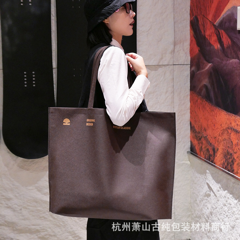 Bolso de mano no tejido de gran capacidad personalizado LOGO engrosado ropa de mujer protección ambiental bolsa de publicidad bolsa de compras de la tienda de ropa