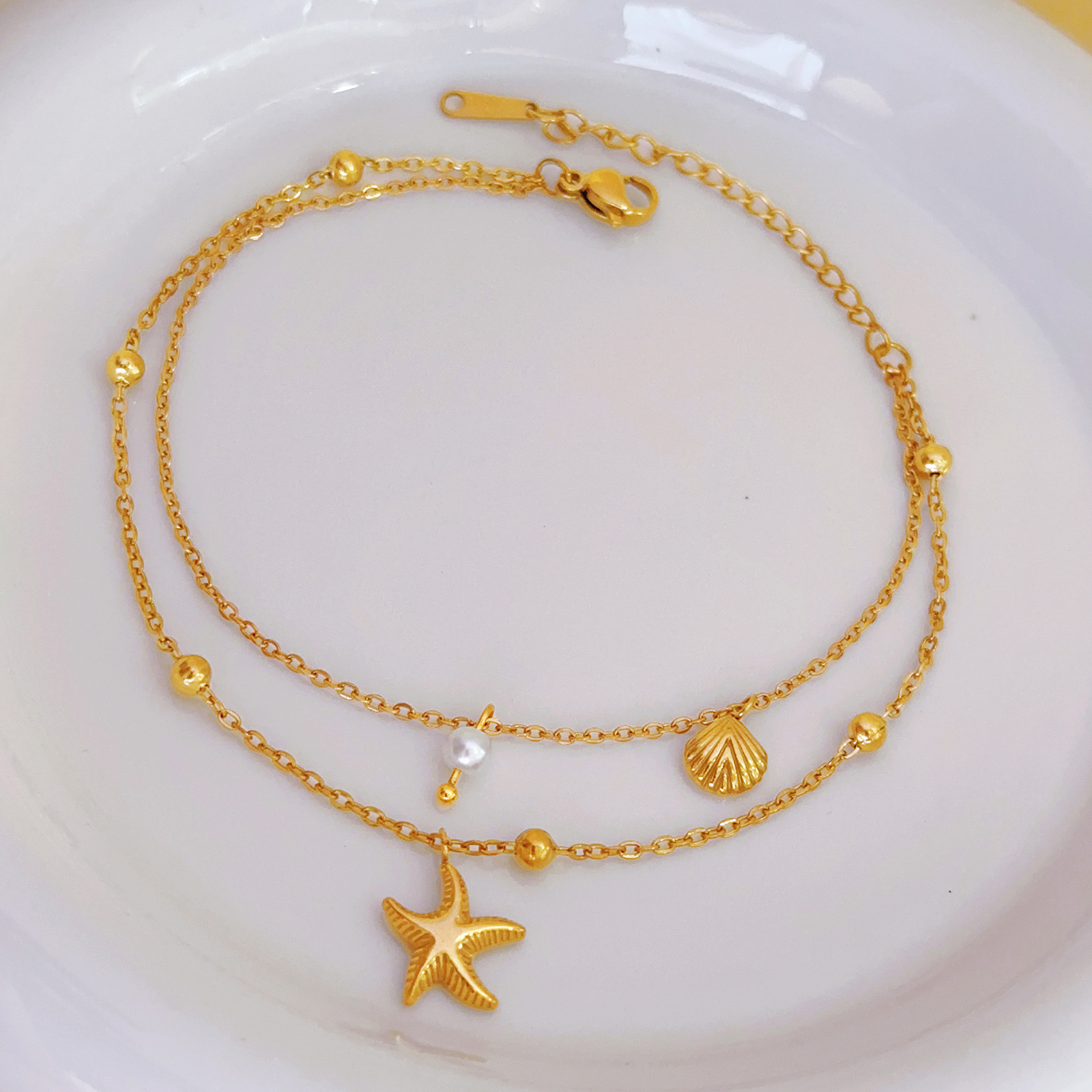 Nuevo estilo transfronterizo europeo y americano, cadena de pie de concha de estrella de mar, lujo ligero, nicho, tobillera de viento frío, joyería de todo fósforo de lujo ligero femenino