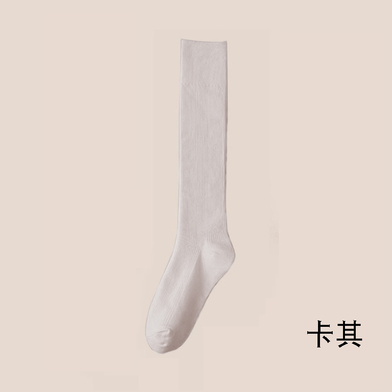 縦条のふくらはぎの靴下の女性の春秋の圧力の長い筒の靴下はやせていることができます。