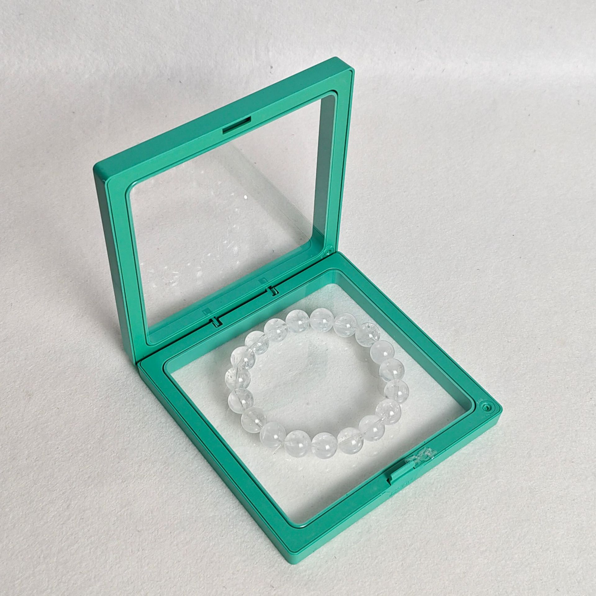 Light green pe film box; length and width 9*9cm, thickness 2cm