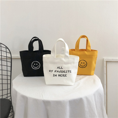 Korean Version 2025 New Smiling Face Ins Style Super Hot Canvas Bag for Girls Students Bento Mini Handbag Wholesale