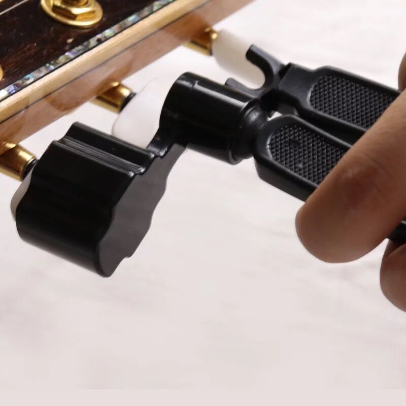 Juego de herramientas de cambio de cuerdas de guitarra multifunción cortador de cuerdas de tres en uno cortador de cuerdas extractor de uñas dispositivo de rodadura accesorios de guitarra