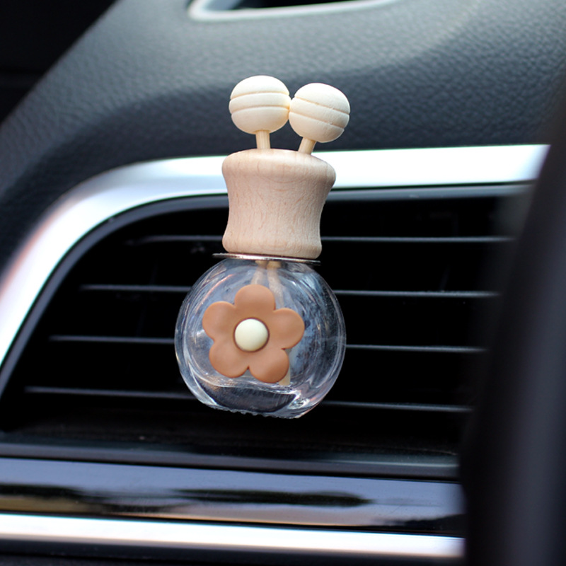 Salida de aire de perfume de coche, dibujos animados, celebridad de Internet, botella de aromaterapia de coche, clip de aire acondicionado, accesorios de coche, bowknot tembloroso