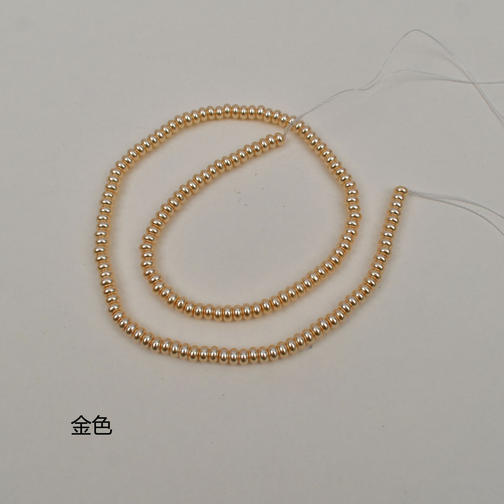 Golden flat beads 2*4mm, about 150 in a string