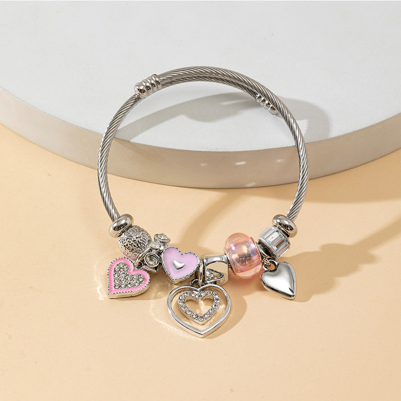 Panjia pulsera Dora DIY cuentas explosivas transfronterizas color rosa goteo amor colgante cuentas de cristal pulsera de acero en forma de corazón