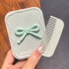 Green three dimensional brush with bow