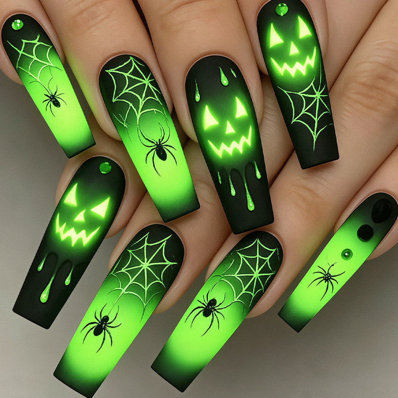 Halloween nail art with green ghost faces, pumpkin, black spider, blood drops, green-black gradient, wearable nail art, high-end boutique Halloween nail art with green ghost faces, pumpkin, black spider, blood drops, green-black gradient, wearable nail art, high-end boutique