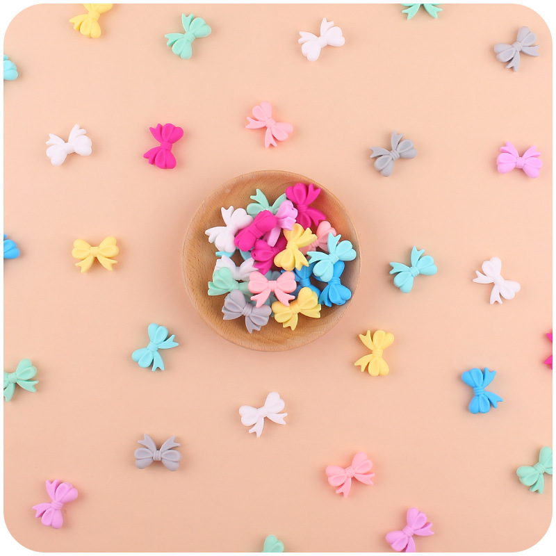 Bebé suministros de dibujos animados de silicona arco pequeño mordedor creativo bebé pezón anti-gota cadena pulsera mordedor Accesorios