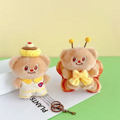 国境を越えたかわいいバター熊のぬいぐるみのキーホルダーアニメの結婚式は人形のかばんのペンダントの小さなプレゼントの卸売りを投げます。