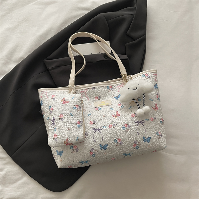2026 flores coreanas mariposas de gran capacidad de viaje de primavera nueva moda moda extranjera bolso de hombro
