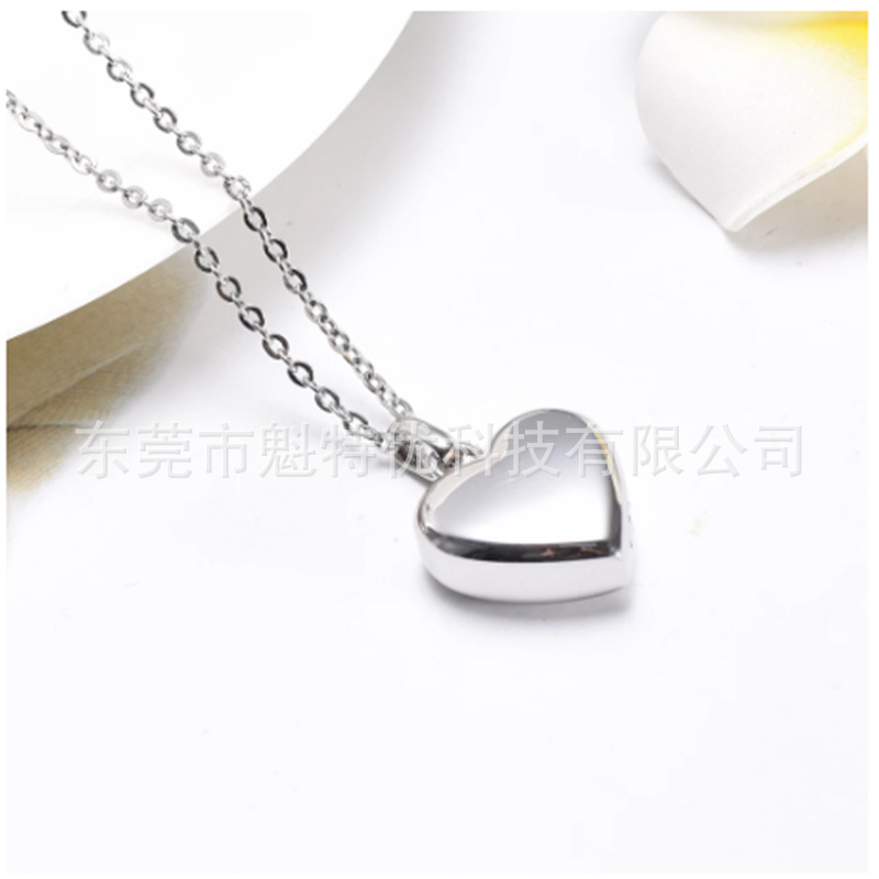 Japonés y coreano nuevo collar de acero de titanio de las mujeres no se desvanece en forma de corazón pata de impresión conmemorativa gato y perro mascota cinerario ataúd colgante impermeable