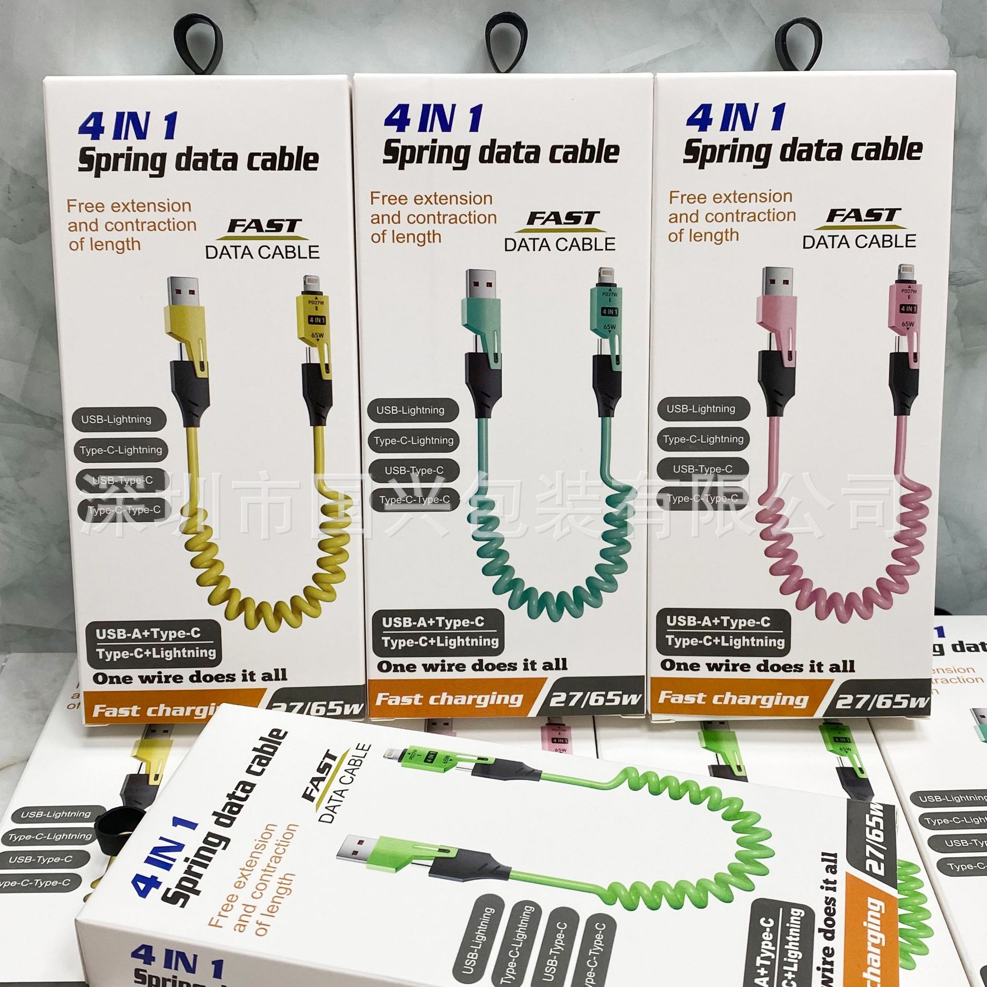 65W resorte telescópico cuatro en uno caja de embalaje de cable de datos neutro cable de datos cargado rápido un arrastre cuatro usb