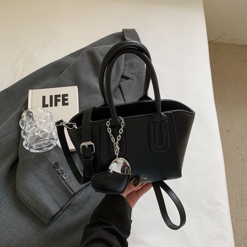 Bolso de cubo portátil de estilo caliente de moda para mujer 2025 nuevo bolso de hombro retro de nicho bolso de mensajero de moda de todo fósforo de moda