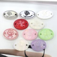 青衿彩色樹脂仿貝殼有眼紐扣標牌櫻桃天使雕刻橢圓扣針織衣標吊牌