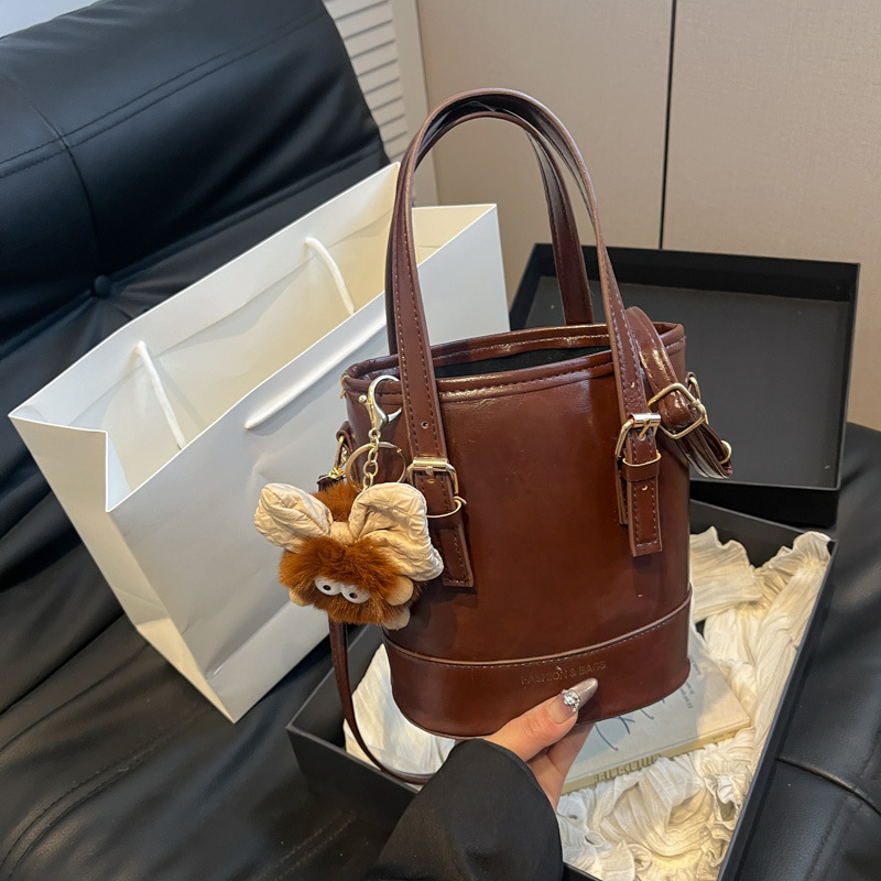 2025 nueva moda extranjera coreana bolso de cubo de mano simple ocio empalme viaje mochila de hombro para mujeres