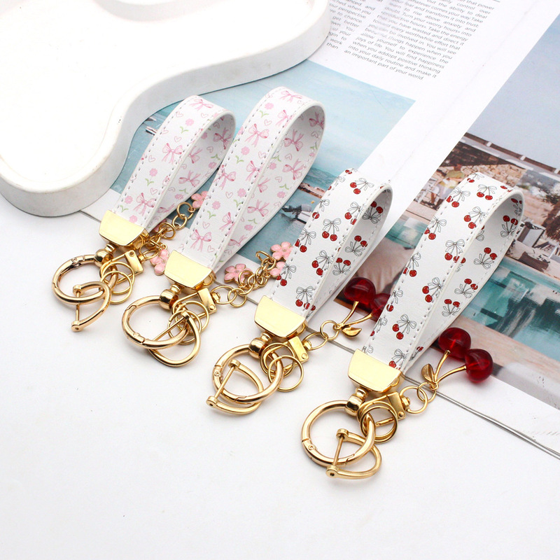 New cross-border PU leather wrist strap keychain with cherry pendant, car keychain, leather keychain accessory New cross-border PU leather wrist strap keychain with cherry pendant, car keychain, leather keychain accessory