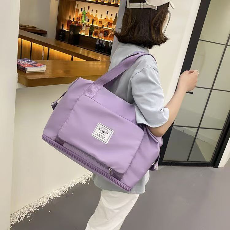 Foldable sports and fitness bag with wet and dry separation, made of Oxford cloth, for outdoor travel, carry-on luggage, and duffel bag.