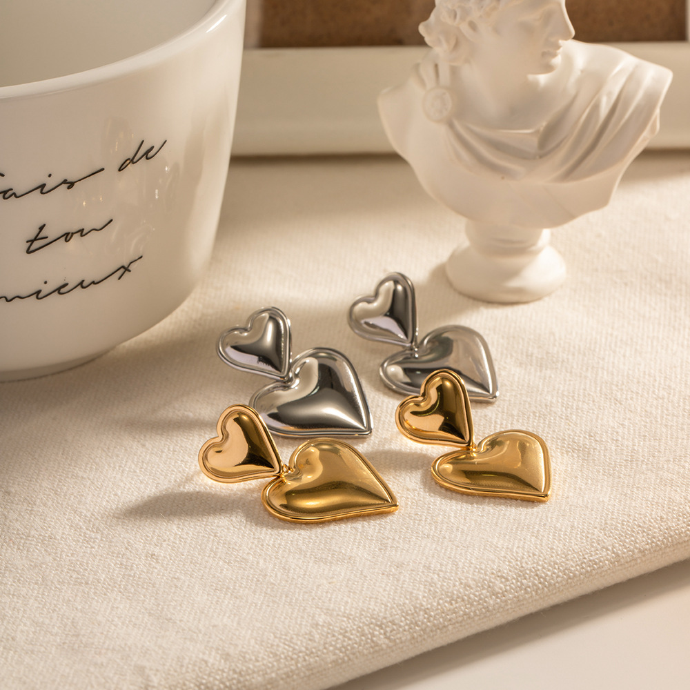 Europea y americana transfronteriza no se desvanece pendientes colgantes encantadores de las mujeres de alto grado de nicho de oro y plata de color a juego pendientes dobles de acero de titanio laminado