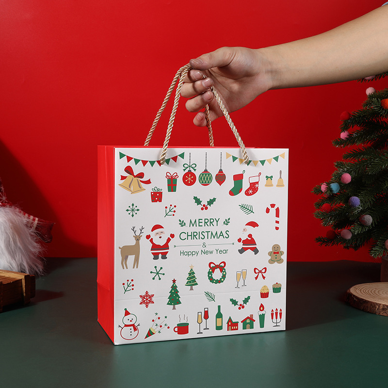 新しいクリスマスプレゼント袋クリスマスプレゼント袋赤い平安夜紙袋の大きなマフラーは包装袋を持っている|undefined