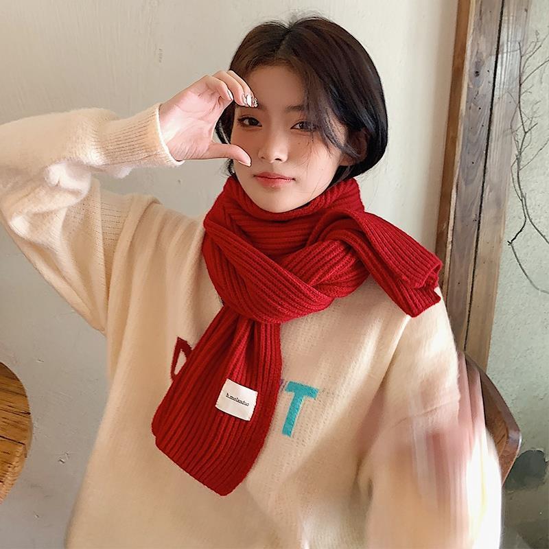 スターは柔らかい北極の毛のマフラーを組み合わせています。女性の冬の学生は赤い保温ニットのカップルを厚くして首を囲みます。|undefined