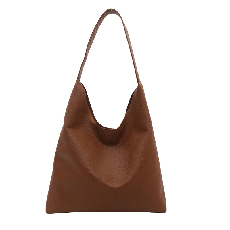 Bolso de mujer retro de gran capacidad de superficie suave casual 2024 nuevo estilo otoño e invierno bolso de hombro con patrón de agarre de mano moda bolso de cubo Tote