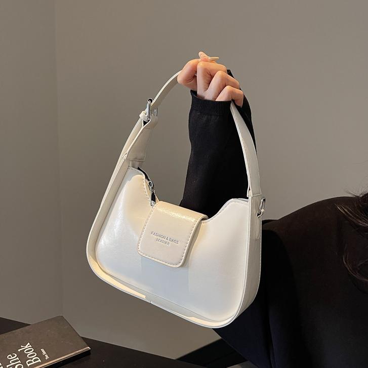 Nicho Zhong simple y versátil bolso de brazo para mujeres 2025, nuevo estilo de moda casual bolso de hombro de alta sensación bolso de media luna de mano