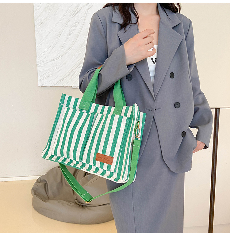 Popular striped canvas 2024 new commuter large capacity casual fashion personalized hand-held crossbody tote women's bag_voghion.com