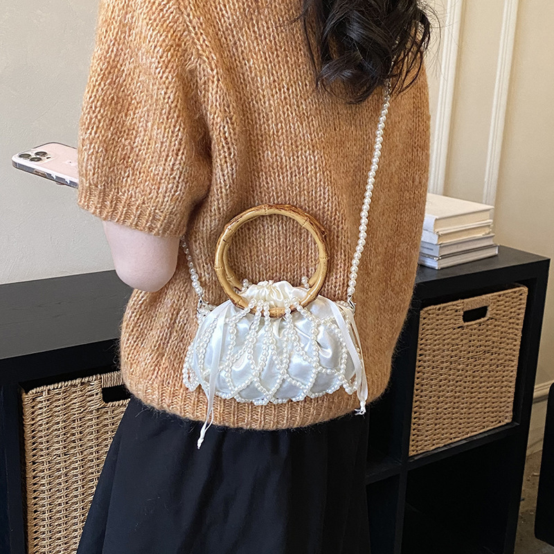 Nueva bolsa china de tejido para niños y niñas bolsas de hombro de perlas de bambú hueco bolsas de mano pequeñas bolsas de cuerda de dibujo para niños