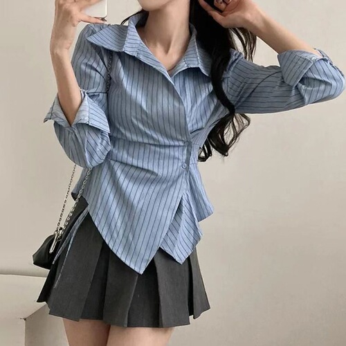 A stylish women's new spring collared shirt with a design featuring irregular cinched waist for a slimming effect, striped long sleeves, and a trendy vibe.