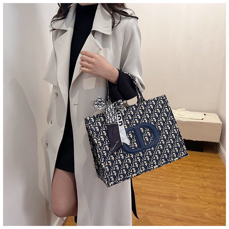 Bolsa grande para mujeres 2025 nueva moda red lienzo rojo de moda bolsa de hombro brazo universal de gran capacidad bolso de mano