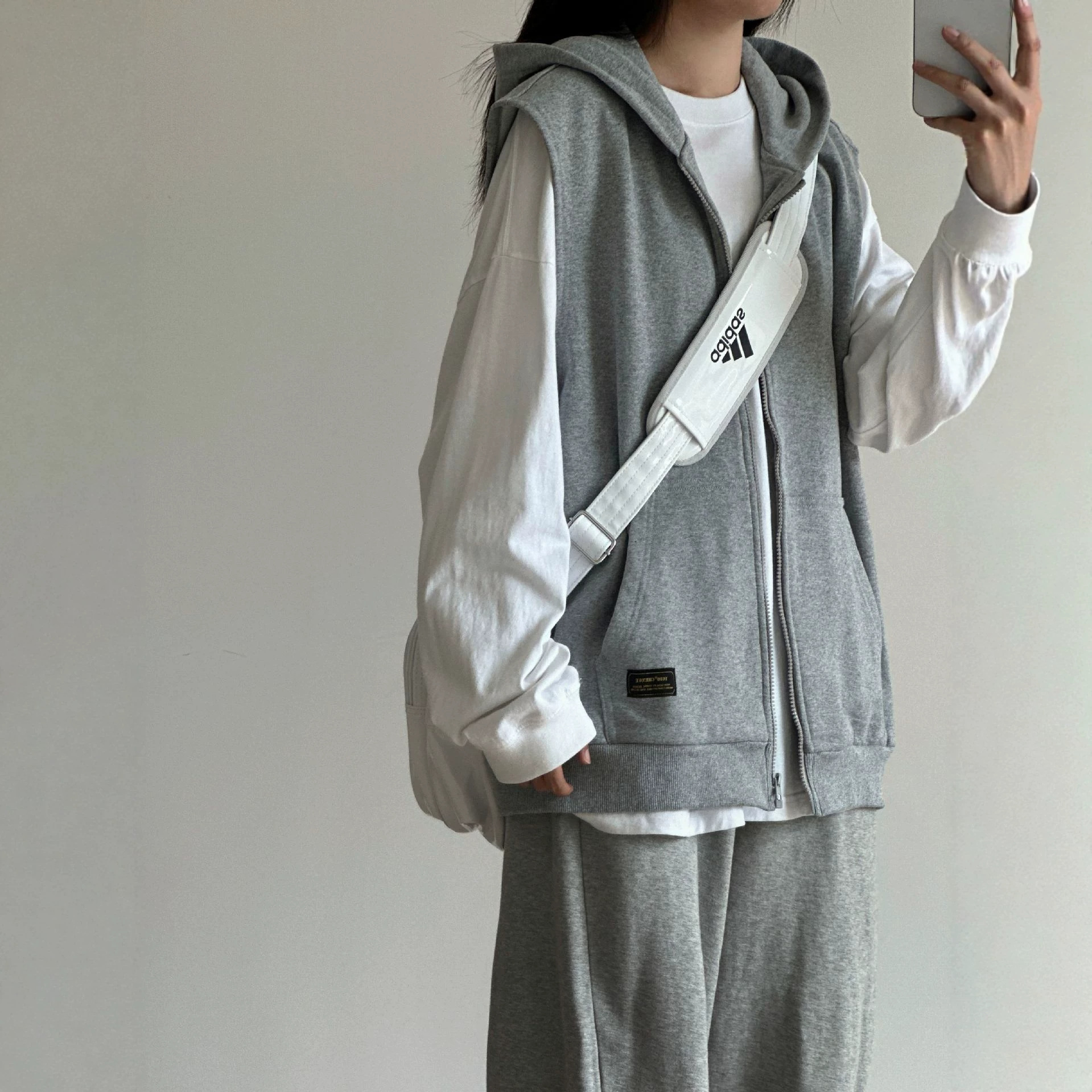 Heather gray sleeveless sweatshirt vest for men, a sophisticated autumn outfit, a couple's clean fit jacket.