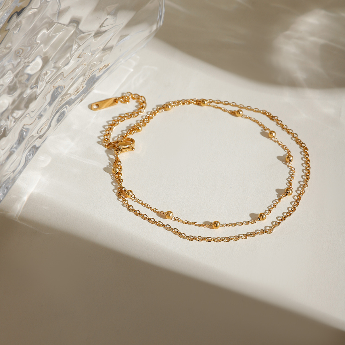 Accesorios de verano nuevos nichos europeos y estadounidenses de moda versátil 18k oro acero inoxidable doble cadena de bolas joyerías de tobillas para mujeres