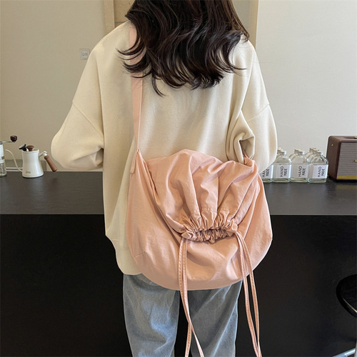 Stylish, versatile drawstring-closure crossbody bag with a minimalist, chic design—perfect for women. Bold-colored, lightweight, and easy-to-hold handbag option.