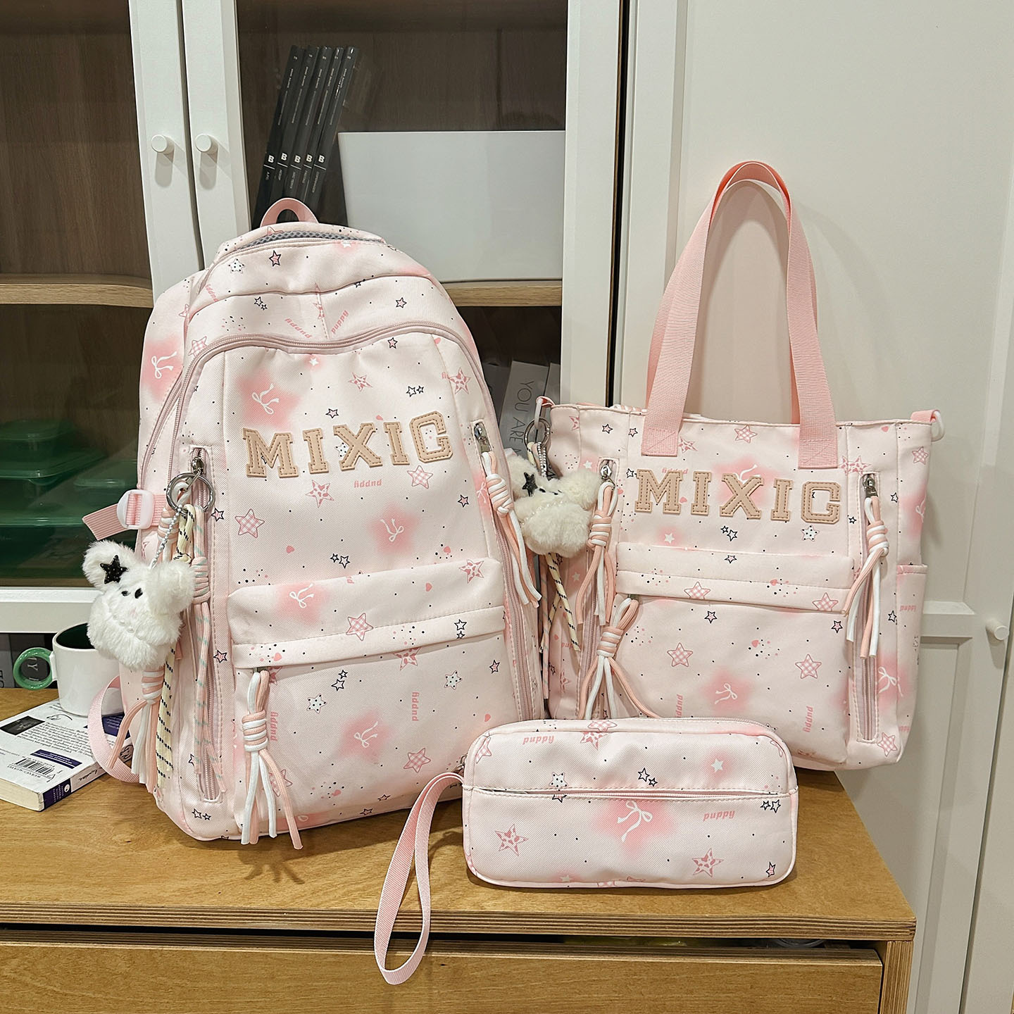 Pink three-piece set with 2 black star and white fur rabbit pendants