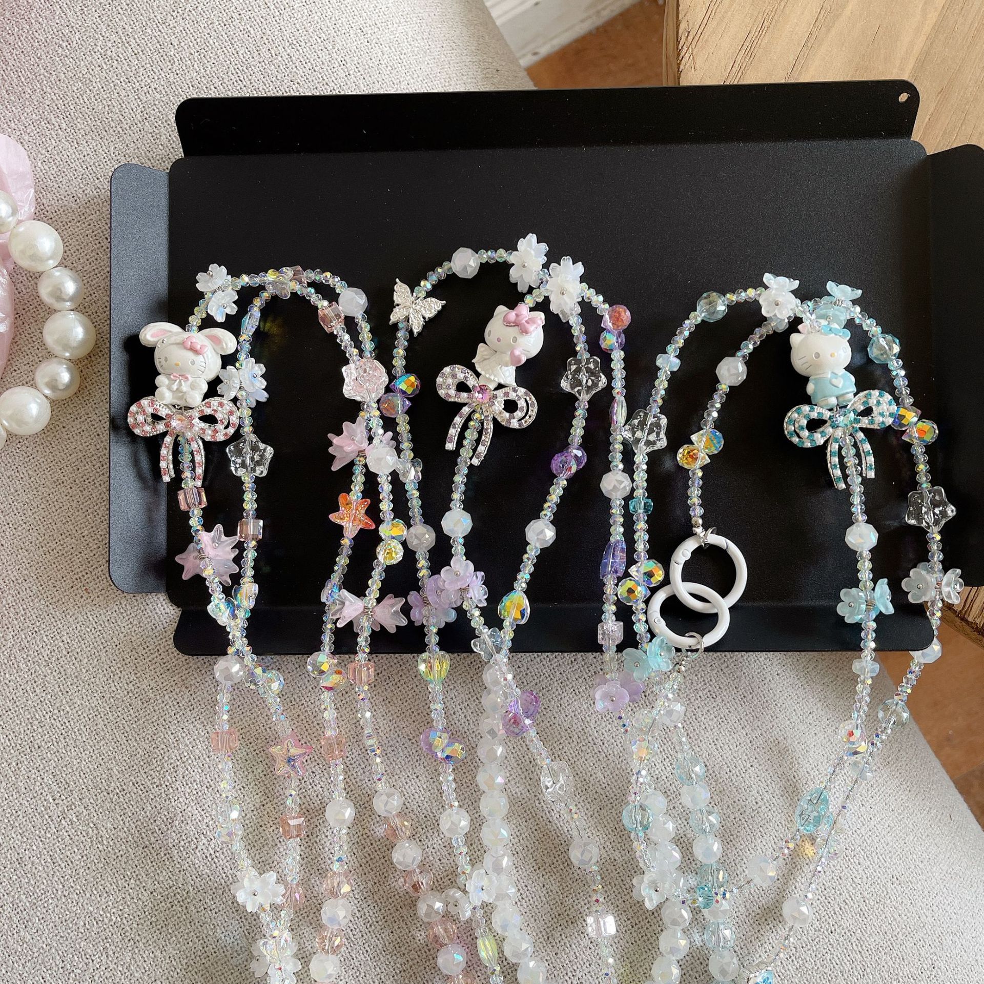 Boutique hecho a mano de alta gama para teléfono móvil cadena larga de gato KT lindo femenino cordón de teléfono móvil de moda colgante de mensajero largo