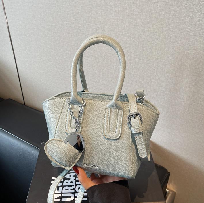 Bolso de cubo portátil de estilo caliente de moda para mujer 2025 nuevo bolso de hombro retro de nicho bolso de mensajero de moda de todo fósforo de moda