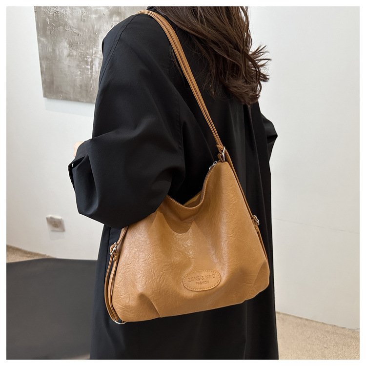 The 2024 new pleated tote bag is a large-capacity casual and fashionable backpack for women, featuring multi-functional texture and a single-shoulder crossbody bag undefined