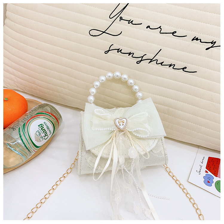 Nuevo bolso de moda para niños bolso de perla animado lindo arco de botón bolso de hombro de niñas cadena diagonal bolso pequeño