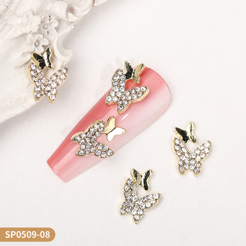 Venta caliente transfronteriza mariposa joyería de uñas aleación hueca alas de diamantes estrella de cinco puntas accesorios de decoración de uñas al por mayor