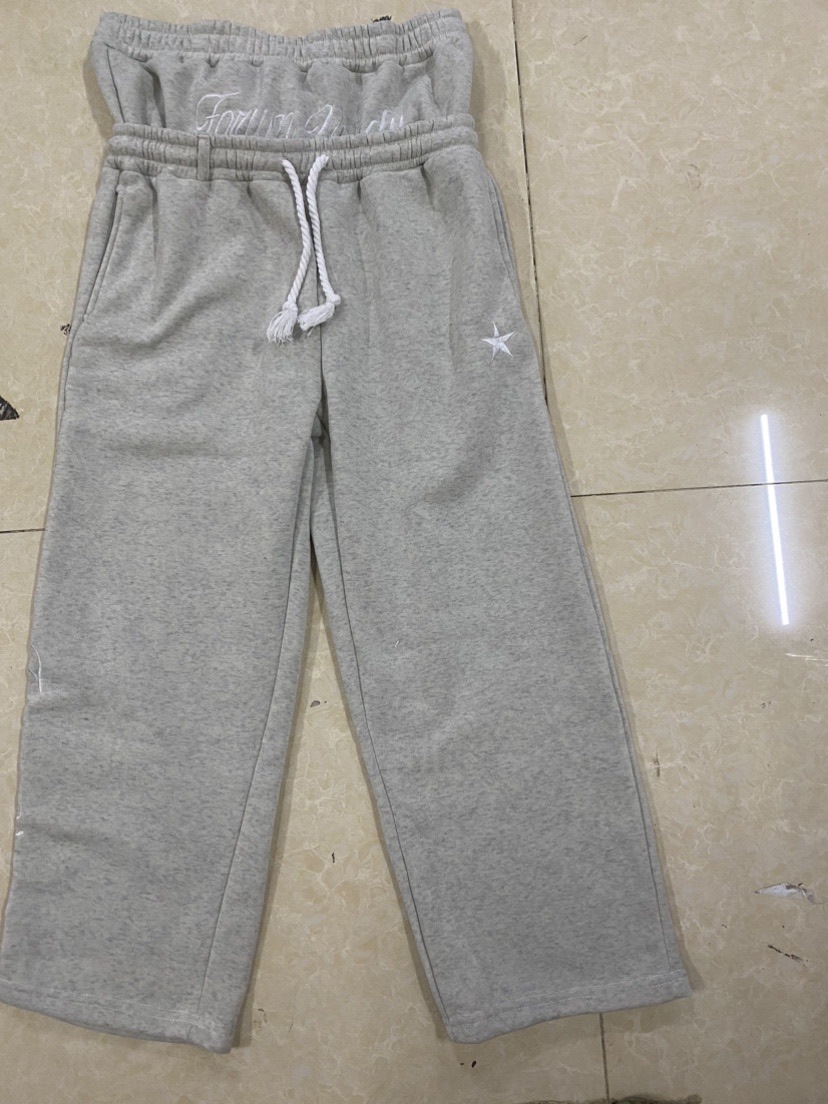 Spot europeo y americano pesado otoño e invierno 2025 principios de primavera doble cintura falso dos pantalones sueltos con cordón pantalones bordados al por mayor
