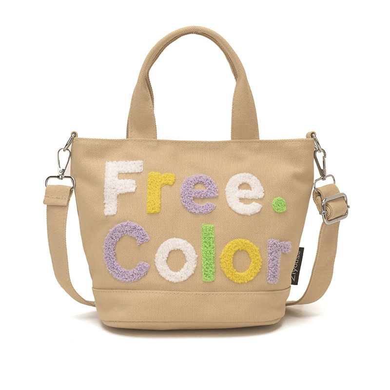 Mamá bolso para salir bolso de cubo de mano mujer 2026 nuevo bolso de lona bordado de dibujos animados letras casuales bolso de mochila