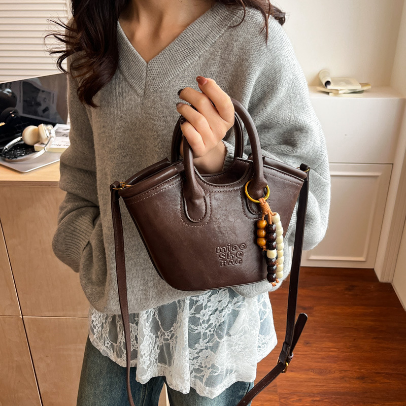 Bolsa de aire coreana para mujeres 2025, otoño y invierno, nuevo estilo de alta calidad, bolso de cubo portátil, bolso de hombro para viajar.