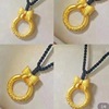 Protective amulet with bow, buckle, gold-plated woven pendant, necklace for princess, golden color