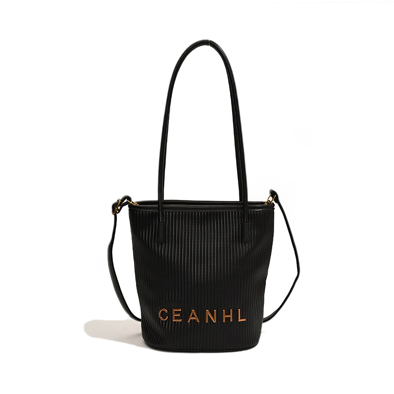 2025 otoño y invierno nuevo pequeño bolso a rayas de viento fragante bolso de cubo simple bolso de hombro de tendencia de mujeres bolso de mochila popular