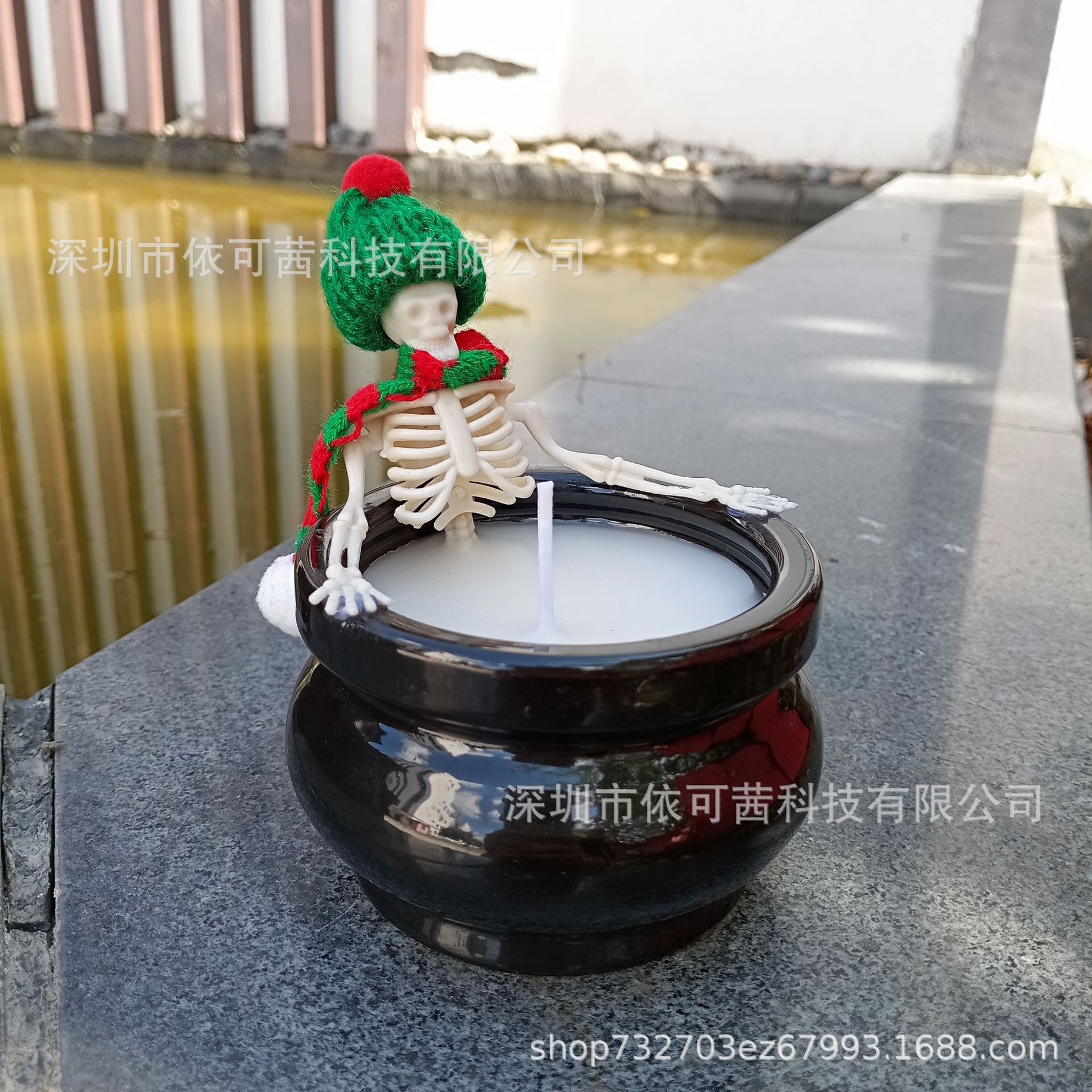 Christmas decoration candle. Candle with Christmas hat and scarf…